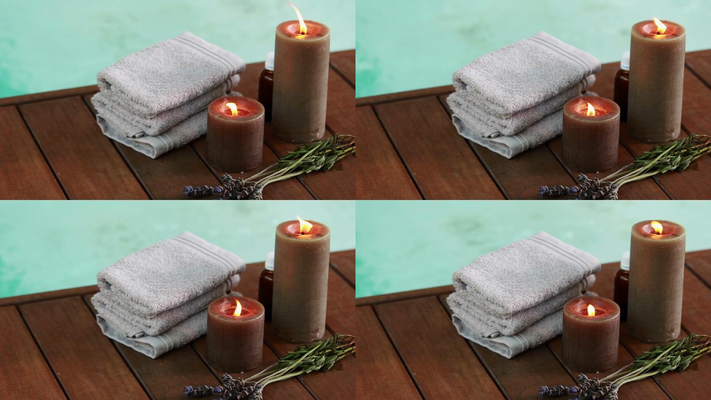 浴巾，蜡烛，还有水疗池边的干薰衣草