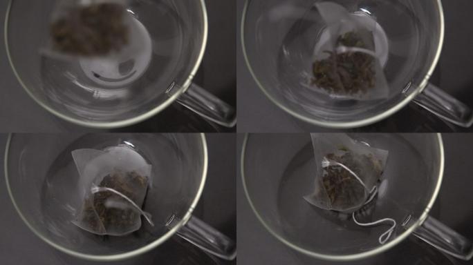 袋泡茶在慢镜头中落入玻璃杯