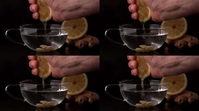 用手把柠檬慢动作挤进一杯热水和姜