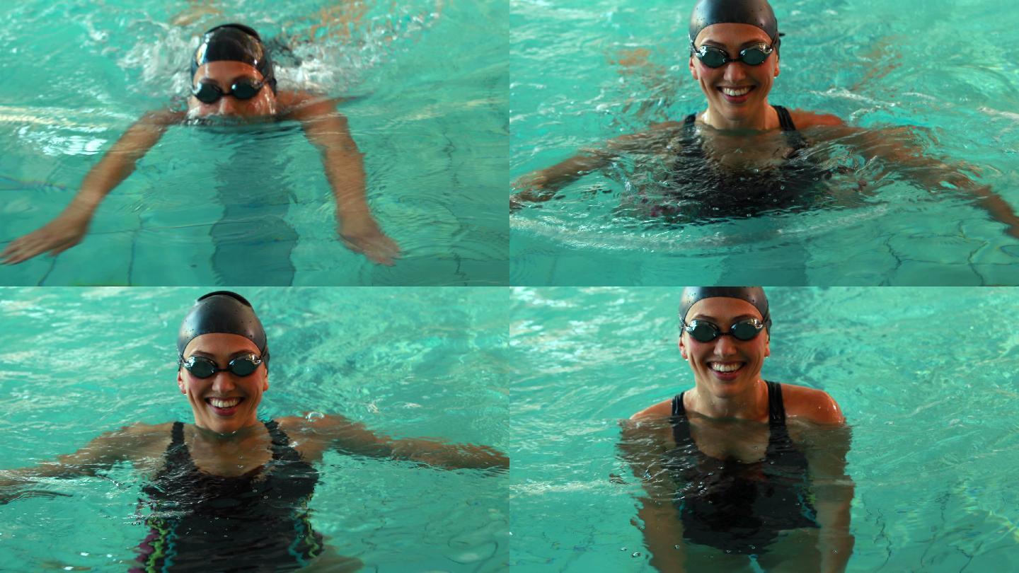 健身游泳者在休闲中心的游泳池对着镜头微笑