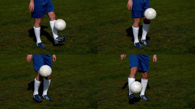 身着蓝色队服的足球运动员以慢动作控制着球场上的球