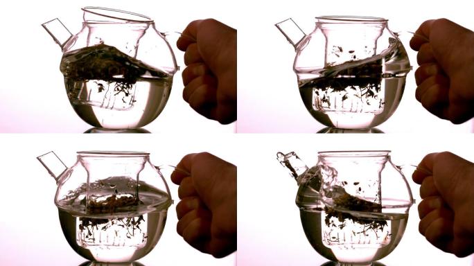 用手在茶壶中慢动作旋转水