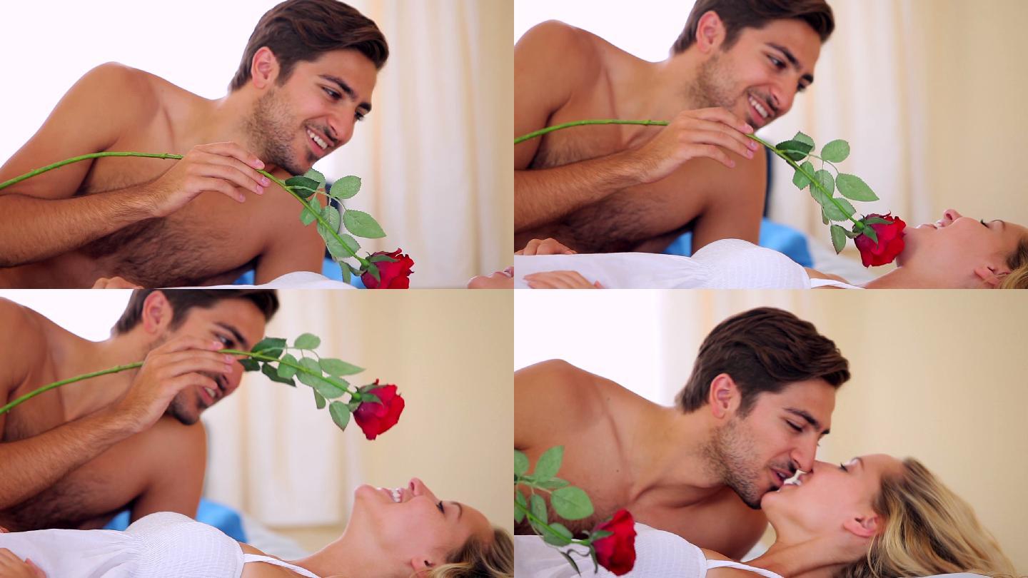 一个西方男子用红玫瑰与女朋友调情