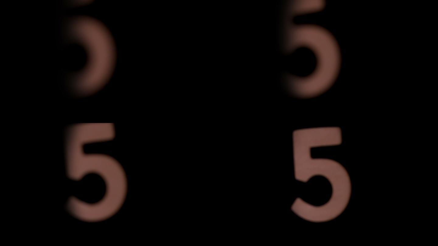 在慢镜头中，数字5在黑色背景上上升