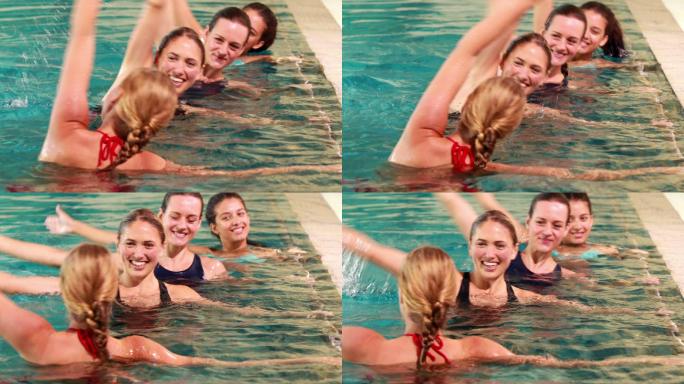 健身妇女在休闲中心的游泳池里做水中有氧运动