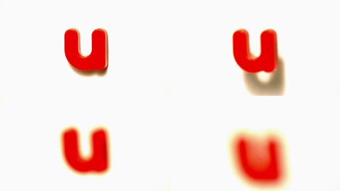 在慢镜头中，红色字母u从白色背景上脱离