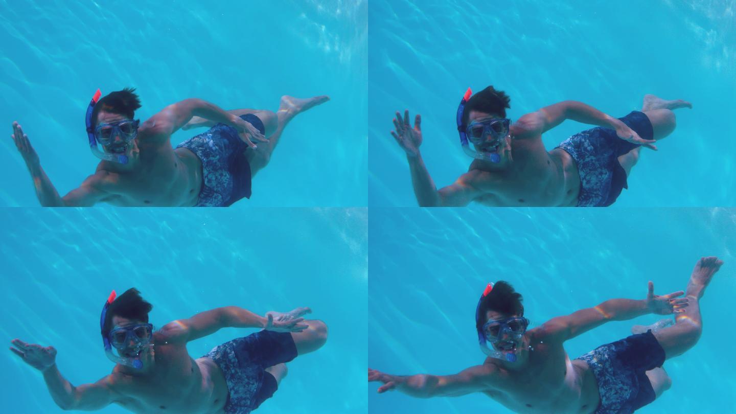 健康人戴着通气管在游泳池里慢镜头游泳