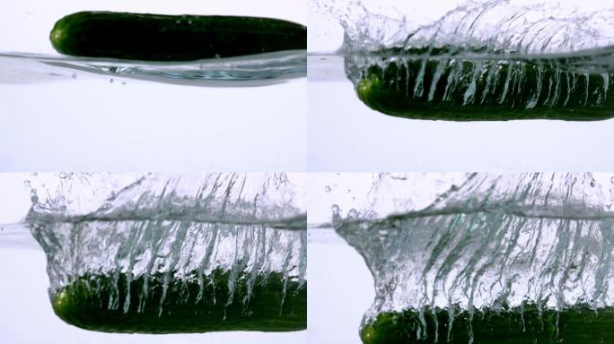 小胡瓜在白色背景的慢镜头中落入水中