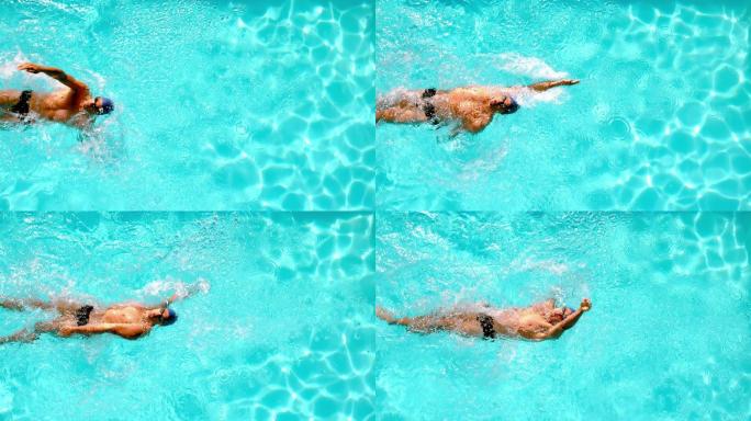 竞技游泳运动员以慢动作游过头顶上的游泳池