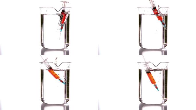 注射器以慢动作落入烧杯中