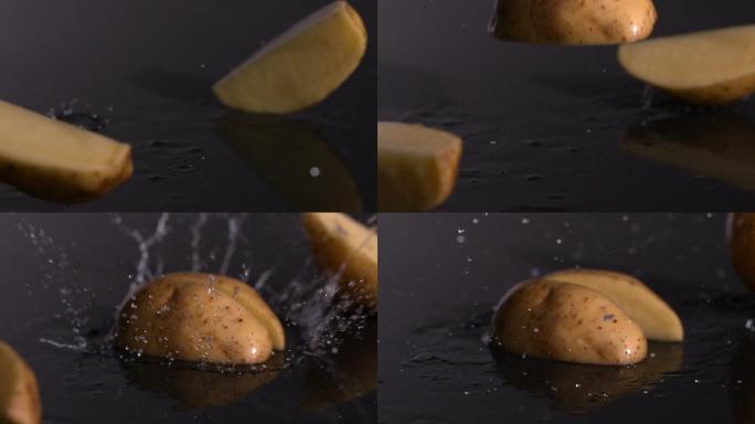土豆片落在潮湿的黑色背景慢镜头