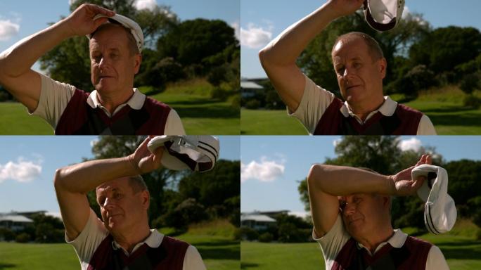 一个成熟的高尔夫球手在大热天脱帽的慢动作