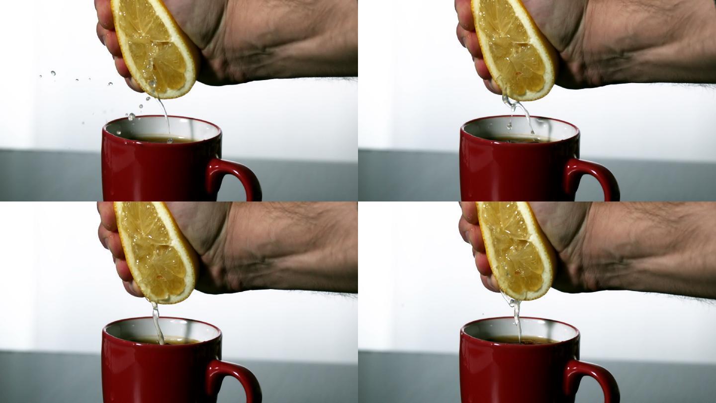一名男子在慢镜头中将柠檬挤进红色杯子里