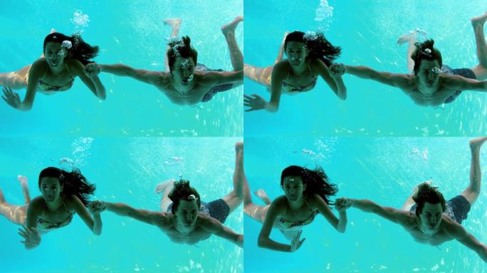 一对夫妇在水下游泳慢镜头
