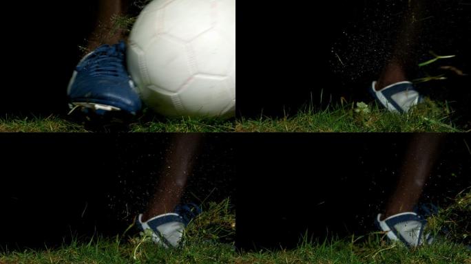 足球运动员在草地上慢动作踢球