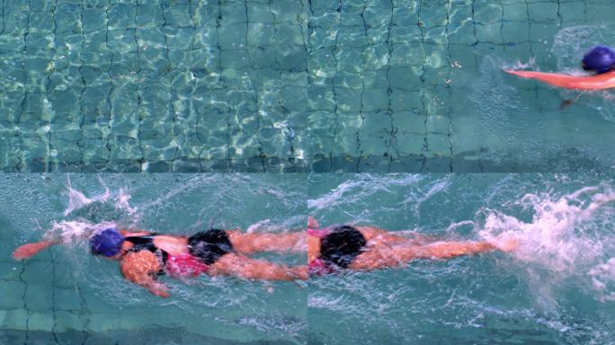 健身女子在休闲中心的游泳池里做前泳