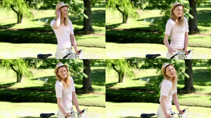 在一个阳光明媚的日子里，一个漂亮的女孩在公园里骑自行车