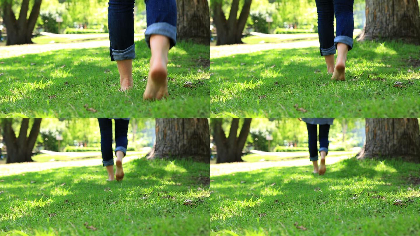 在一个阳光明媚的日子里，一个女人赤脚走在草地上