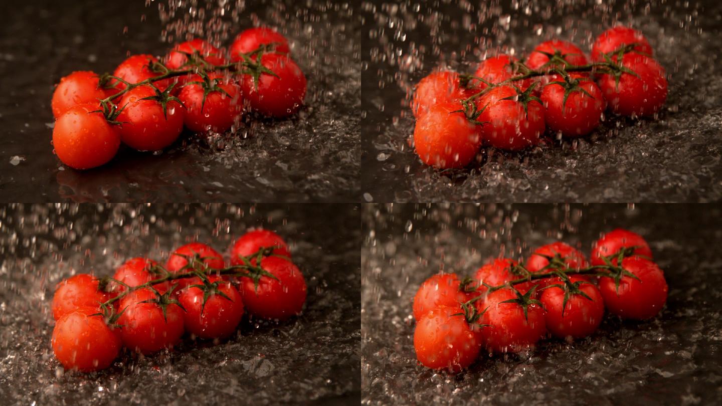 在慢镜头中，水洒在樱桃番茄上