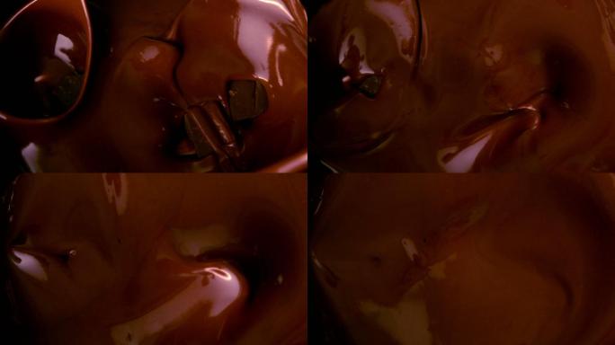 巧克力块落在融化的巧克力中的慢动作