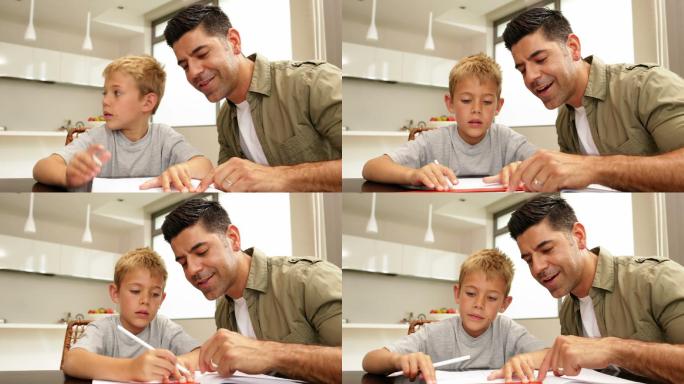儿子和父亲在厨房的餐桌上画画