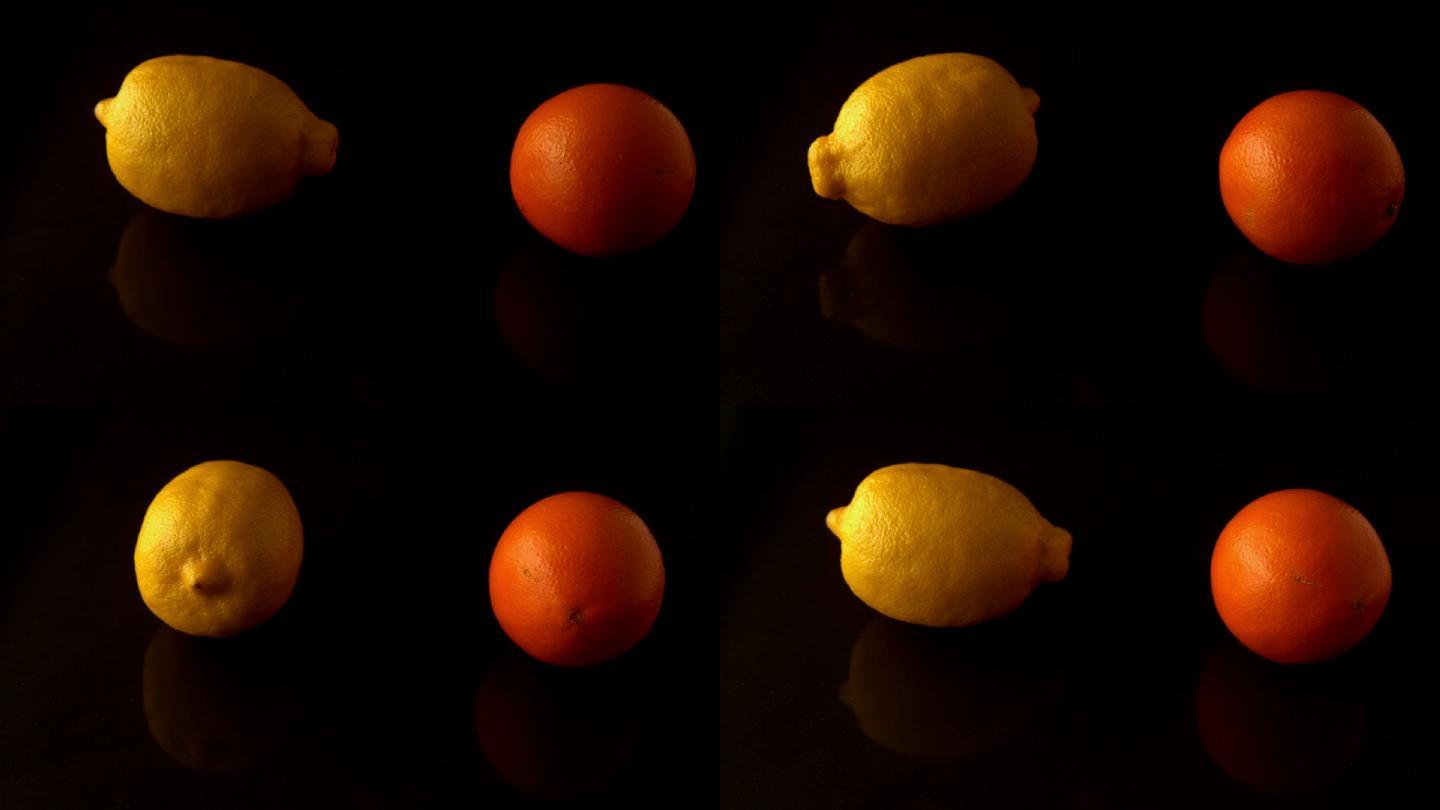 柠檬和橙色在黑色表面慢镜头旋转