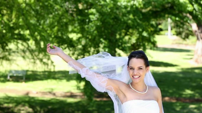 Beautiful bride throwing her bouquet on a sunny da