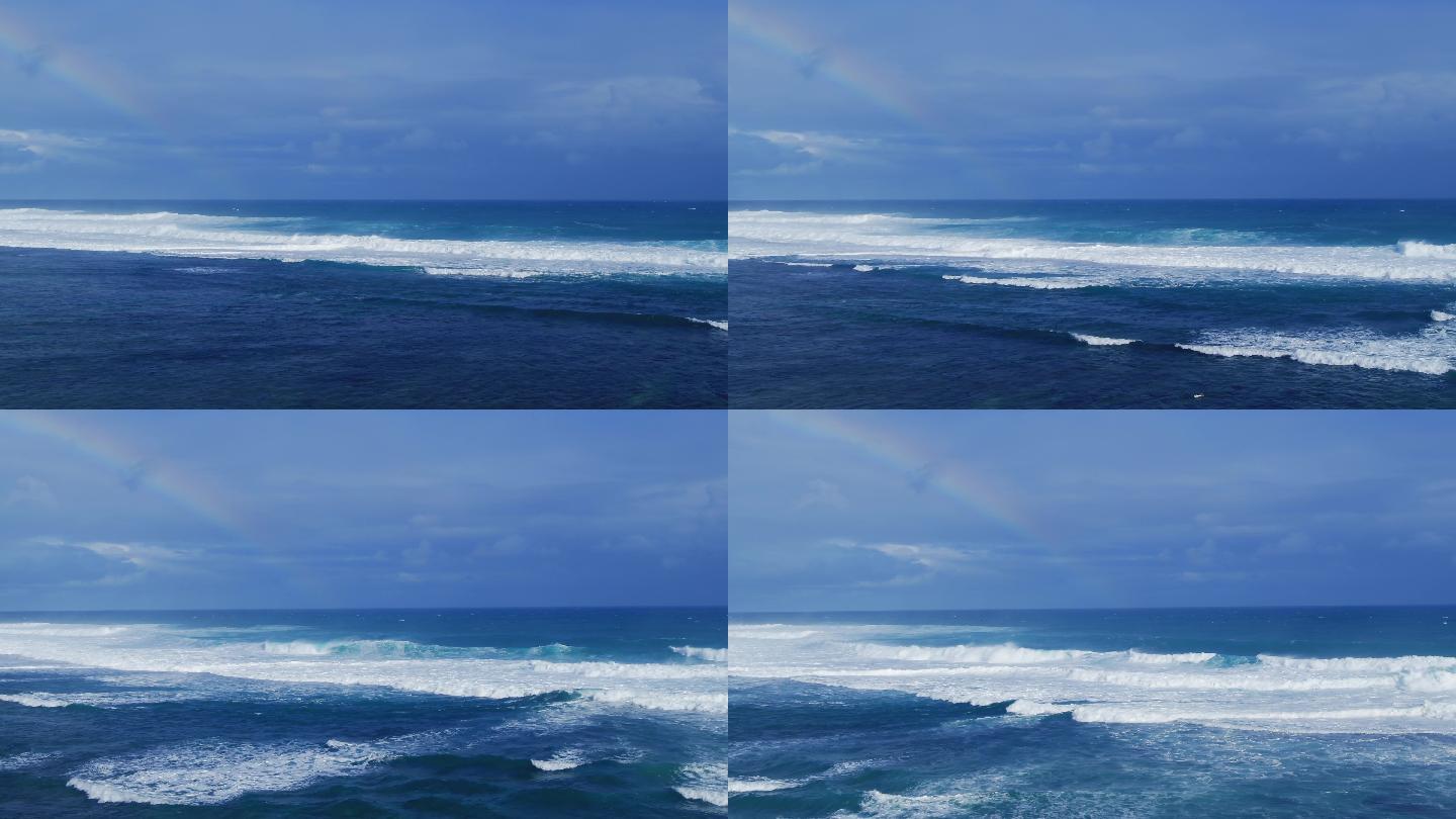 蓝天白云彩虹下波涛汹涌的海面