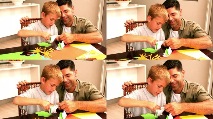 父亲和儿子一起在桌子上用慢镜头做纸的形状