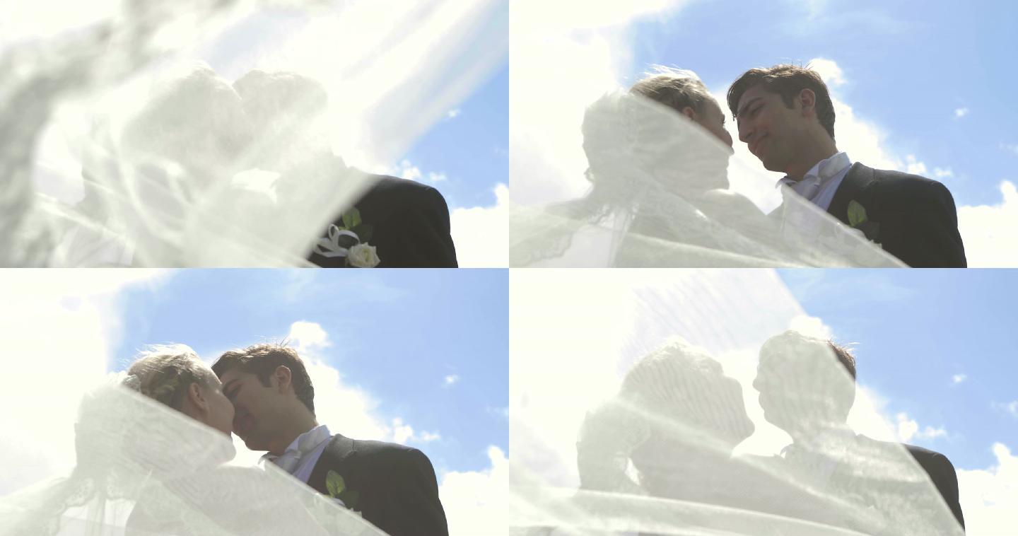在他们结婚的日子里，一个阳光明媚的日子，新娘和新郎在外面互相亲吻