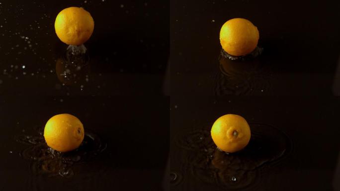柠檬滴在潮湿的黑色表面的慢镜头
