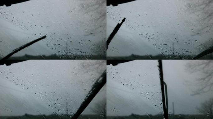 挡风玻璃刮水器以慢动作擦去车窗上的雨水