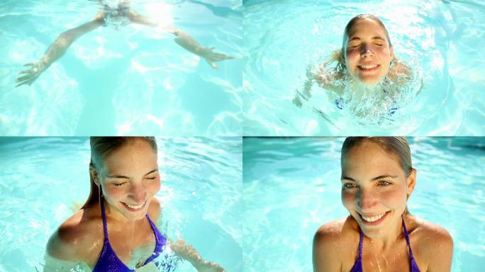 一个阳光明媚的金发美女在泳池里游泳