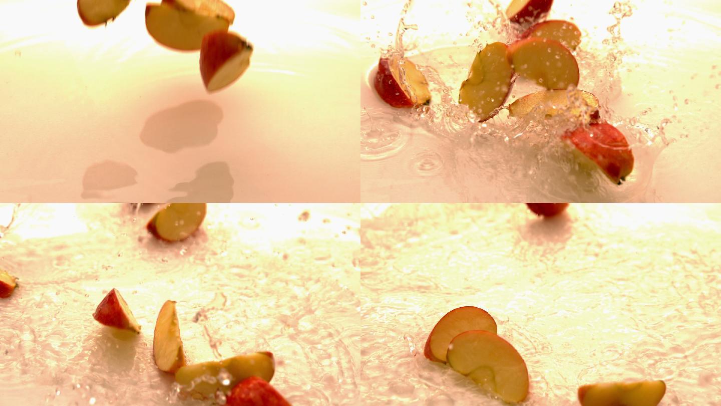 苹果碎片在白色潮湿的表面上缓慢地坠落和弹跳