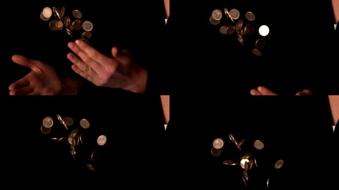 在慢镜头中，一名女子在黑色背景上投掷欧元硬币