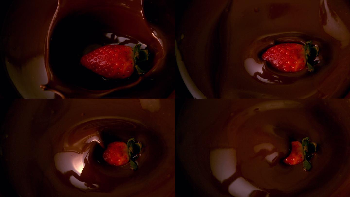 草莓落在融化的巧克力中的慢动作