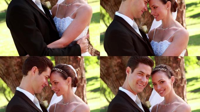 在一个阳光明媚的日子里，一对幸福的新婚夫妇在镜头前拥抱微笑