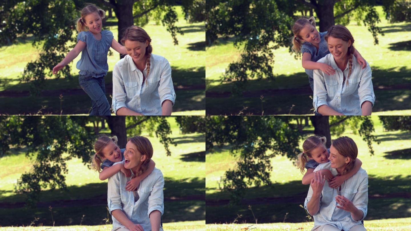 年轻的母亲和女儿一起在公园里放松慢镜头