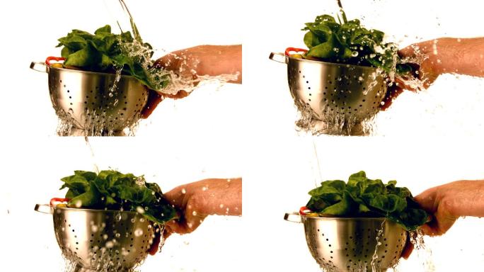 慢动作将水倒在滤锅里的沙拉上
