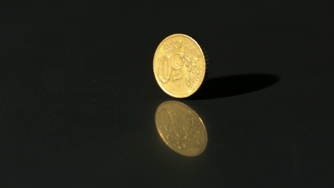 欧元硬币在黑色表面慢镜头旋转