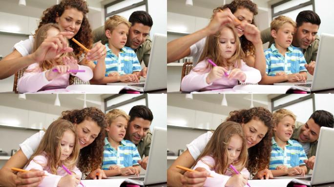快乐的孩子们在餐桌上和父母一起画画，在厨房里用笔记本电脑