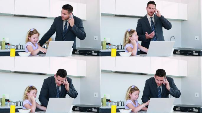 忙碌的爸爸带着女儿上班前在家里的厨房里