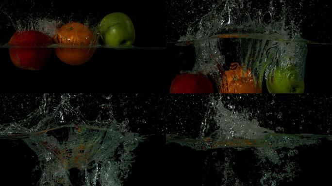 在黑色背景的慢镜头中，苹果橙和酸橙跳入水中
