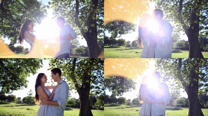 一对快乐的情侣在一个阳光灿烂的日子里在公园里跳舞