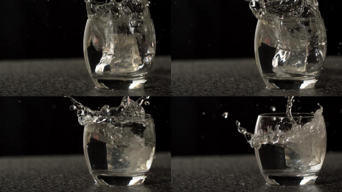冰块在慢镜头中落入一杯水中