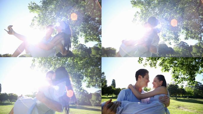 一个男人在一个阳光明媚的日子在公园里接他漂亮的女朋友