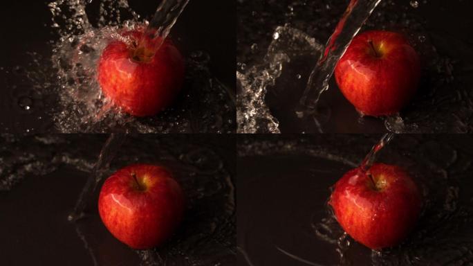 慢镜头中，水倒在红苹果上