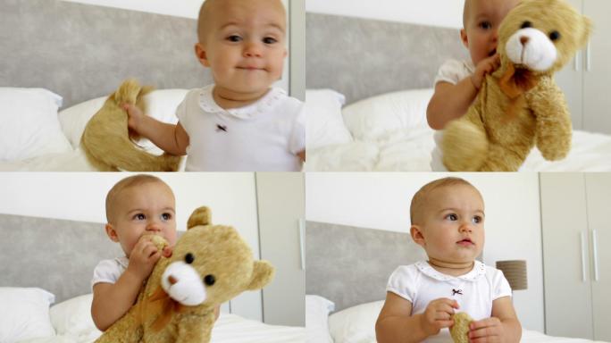 可爱的小女孩在卧室的床上玩泰迪熊