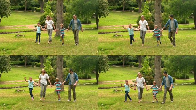 快乐的一家人在公园里蹦蹦跳跳的慢镜头