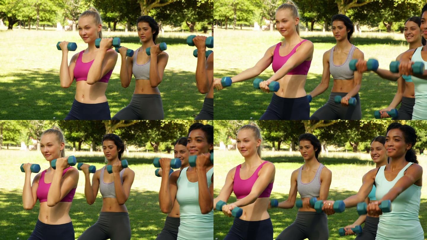 四个女性在公园里用哑铃锻炼